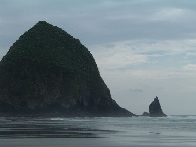 Cannon Beach and Haystack Rock are both located within easy reach of Astoria, Oregon - one of the ports of call visited aboard American Empress. Photo © Aaron Saunders
