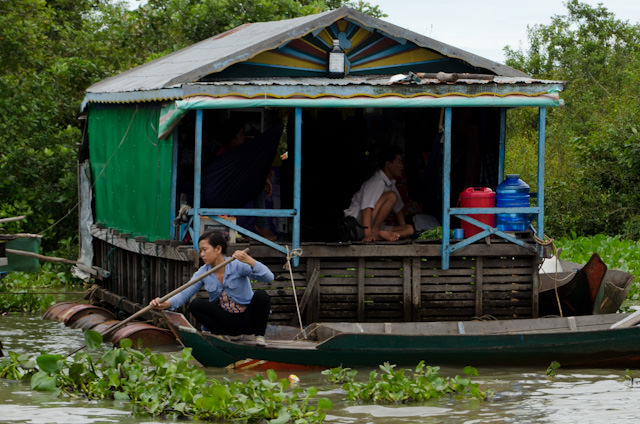 A native Cambodian woman outside her floating house. Photo © 2013 Aaron Saunders