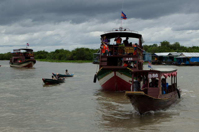 One of the most memorable embarkations ever: a flotilla of ships whisked guests to the waiting AmaLotus on Tonle Sap Lake. Photo © 2013 Aaron Saunders