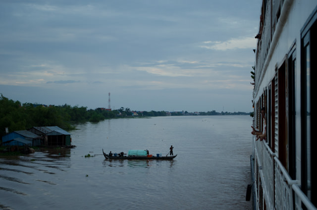 As we sailed for Phnom Penh, children ran along the banks of the river to wave at us, and boats took to the water. Photo © 2013 Aaron Saunders