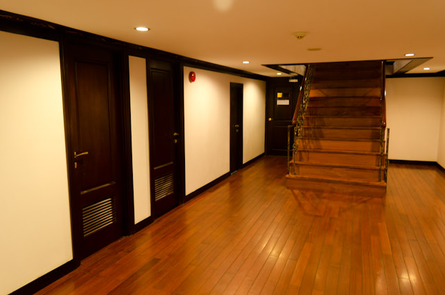 The stateroom corridor on Mekong Deck 0, facing aft towards the stairs up to the Reception Desk. Photo © 2013 Aaron Saunders