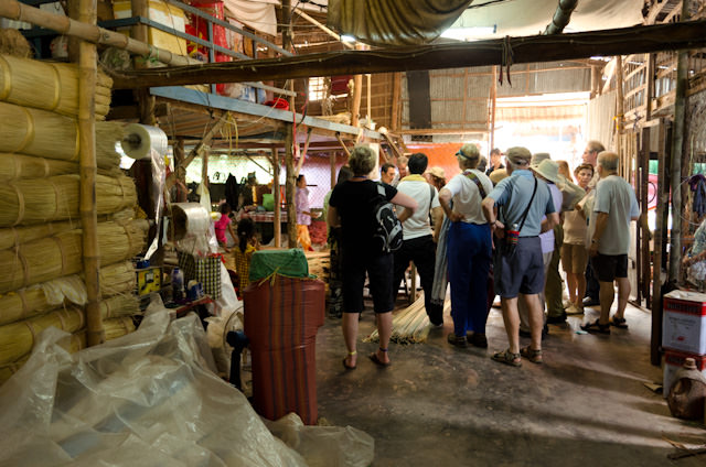 Guests aboard the AmaLotus look on as the process of making rattan mats is explained during a factory tour in Tan Chau. Photo © 2013 Aaron Saunders