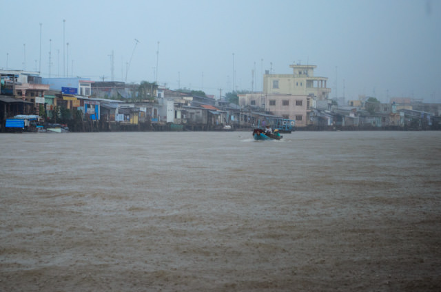 After lunch, the monsoons came out as we neared Cai Be, pictured above. Photo © 2013 Aaron Saunders