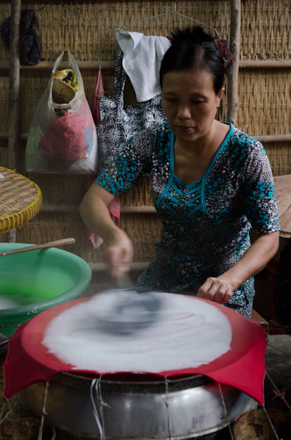 Watching how rice paper is made. It's also surprisingly tasty with a little bit of soy sauce. Photo © 2013 Aaron Saunders