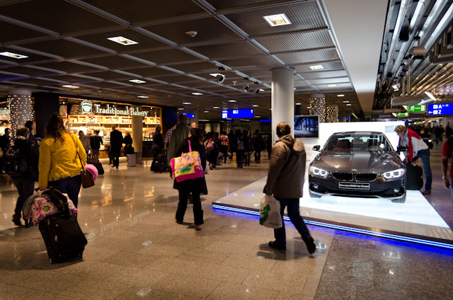 We Must Be In Frankfurt: passers-by admire the squeaky-clean new BMW in Frankfurt's Terminal A. Photo © 2013 Aaron Saunders