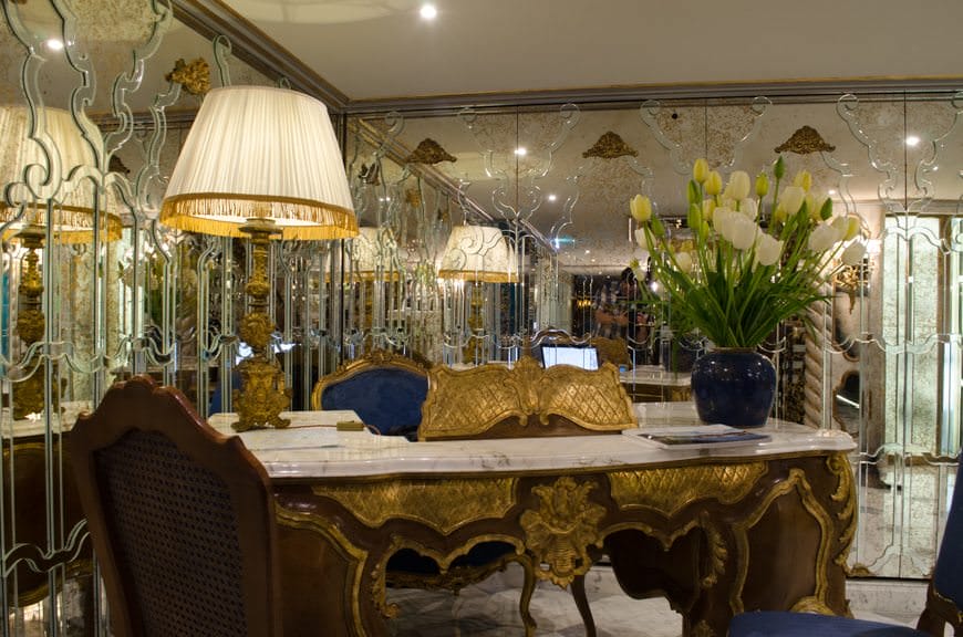 Check out the Cruise Director's desk at the Reception Lobby. The gold partition rising above the desk hides the laptop computer behind it. Clever! Photo © 2015 Aaron Saunders