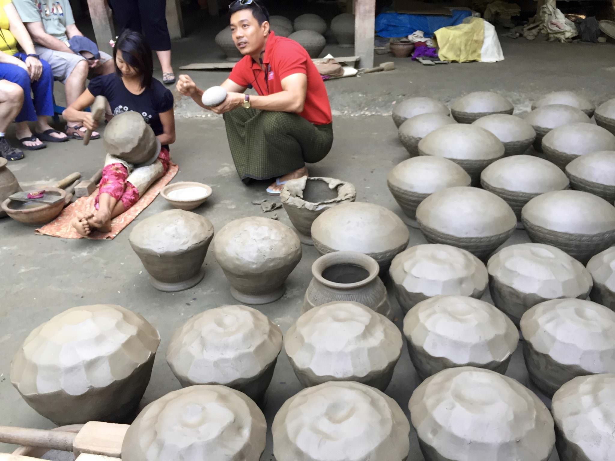 Program Director Nanda explains the process of forming the pots. © 2015 Gail Jessen