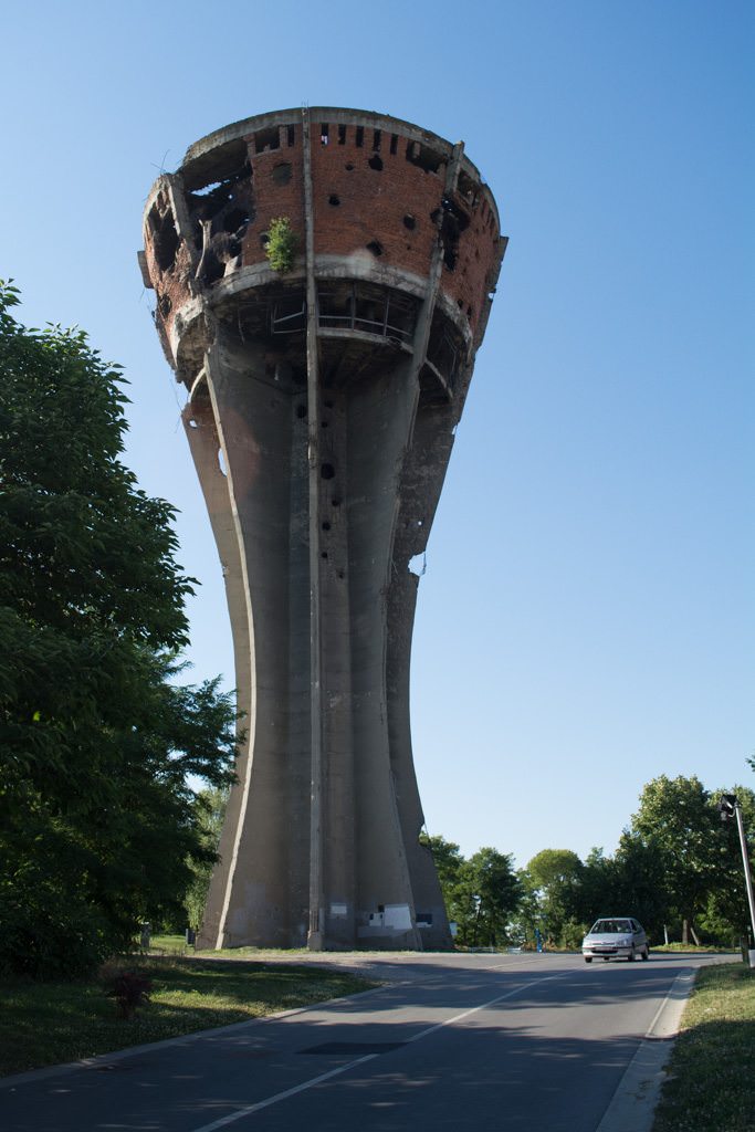 In Vukovar, the city's water tower - which once held a panoramic restaurant - remains riddled from over 600 bombings during the War of Independence in 1991. Photo ©  2016 Aaron Saunders