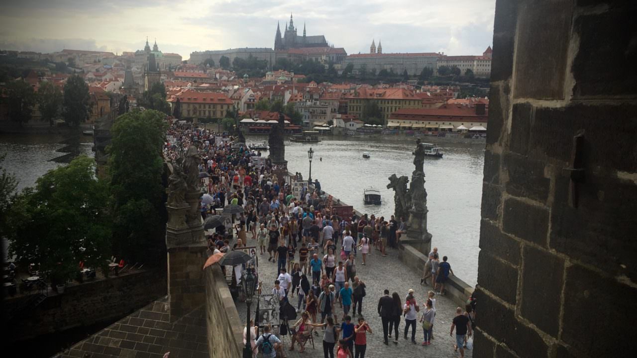 On the Charles Bridge in Prague: While you're at home, Europe is bustling with people and life-enriching adventures. © 2016 Ralph Grizzle